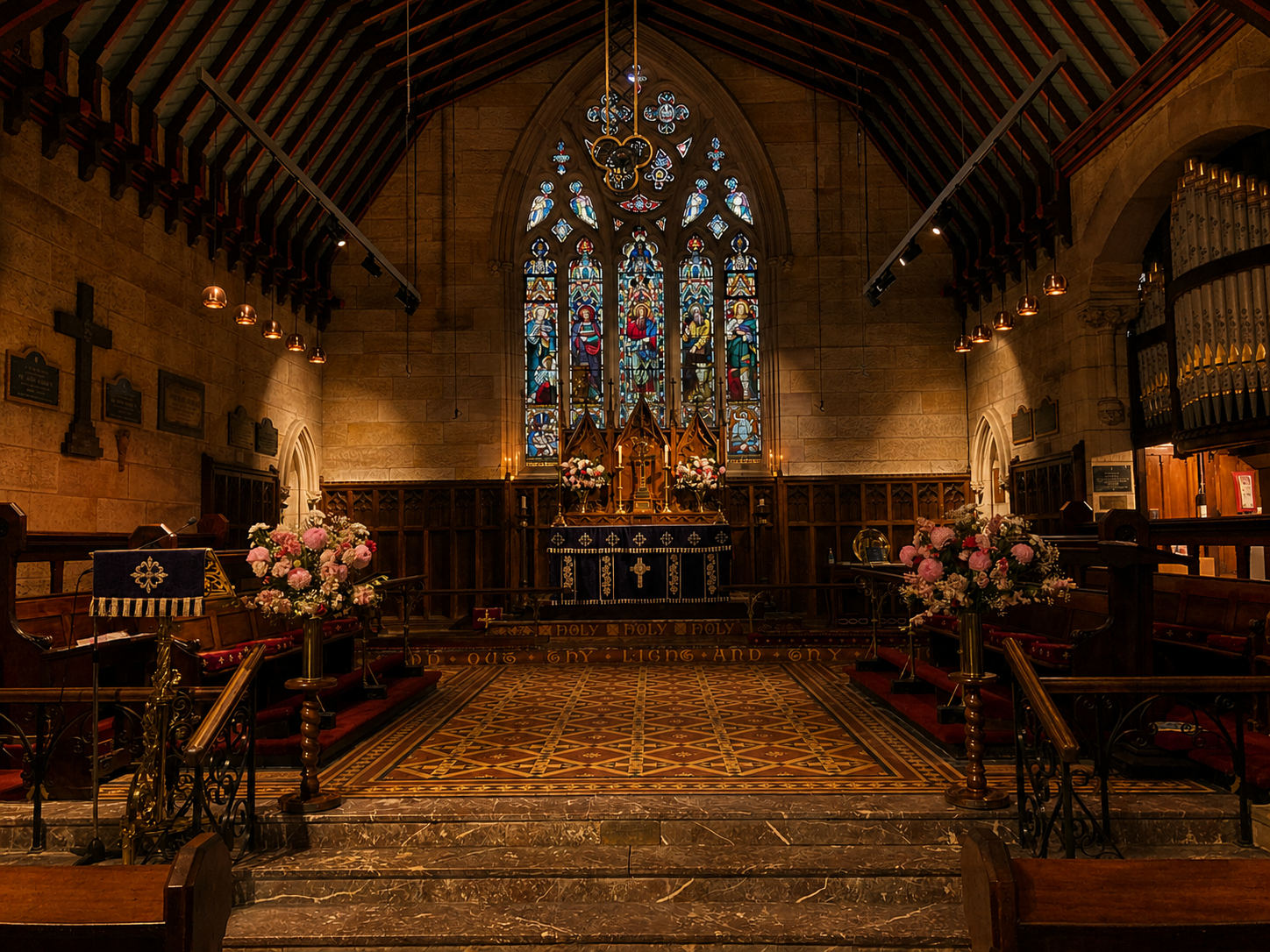 Candlelit historic stone church sanctuary with stained glass and altar